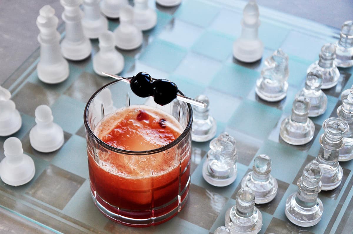 Manhattan cocktail on a glass chess board
