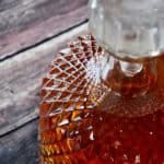 Homemade Gin in a refillable bottle on a wood table