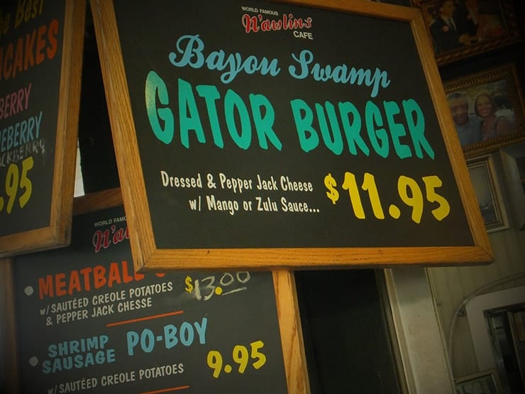 Sign from Bayou Swamp restaurant selling a gator burger for 11.95