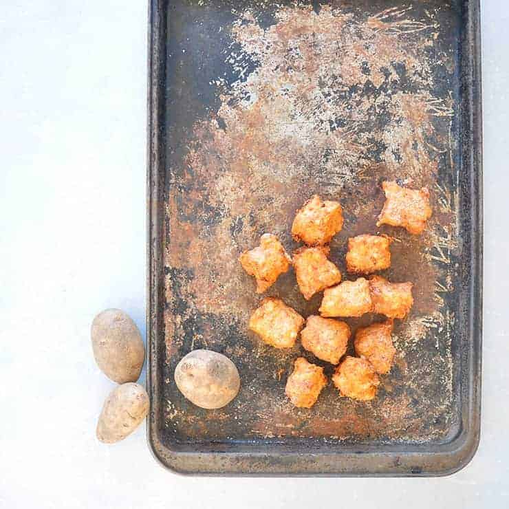 Tater tots on a pan with potatoes.