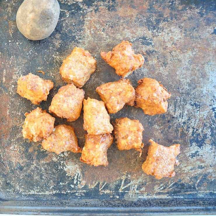 Tater tot recipe feature image. Tater tots on a pan with a potato.