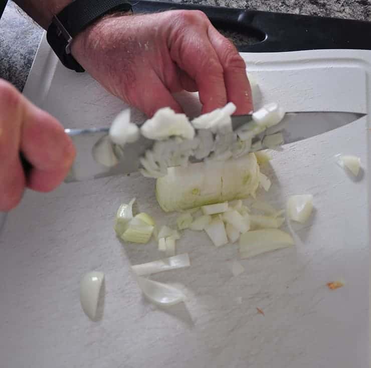 chopping an onion with my Wustoff knife in preparation for making a hot dish recipe.