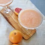 greyhound frozen margarita on a serving plate with some grapefruits in the background