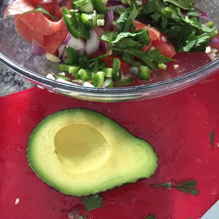 nice avocado with ceviche mixings ready in the background