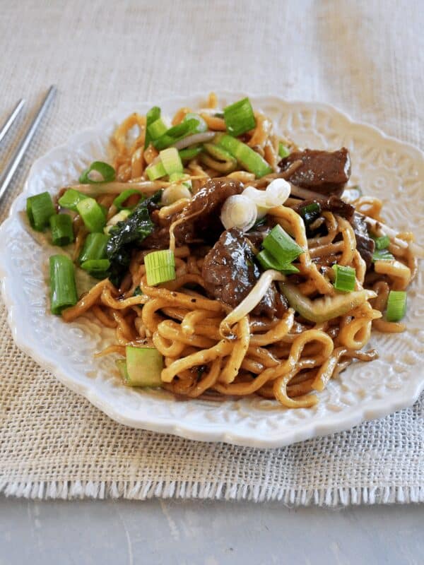 Beef Chow Mein from the side with chop sticks.