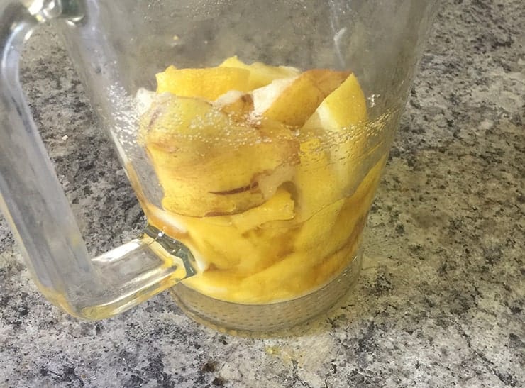 pitcher with pear, lemon, mango, sugar, and brandy in it just waiting for wine to be the final Sangria ingredient.