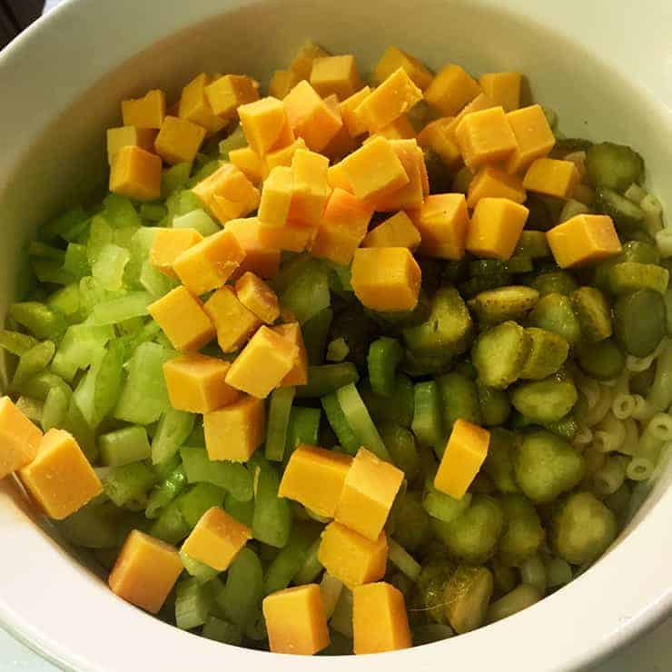 This is a bowl of macaroni salad before adding mayo and before it is mixed.