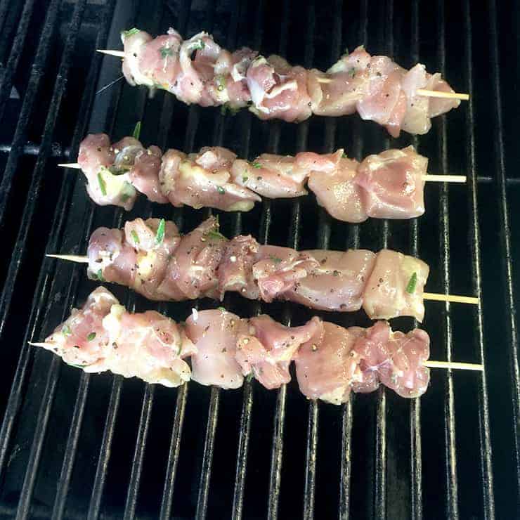 Chicken skewers on the grill cooking.