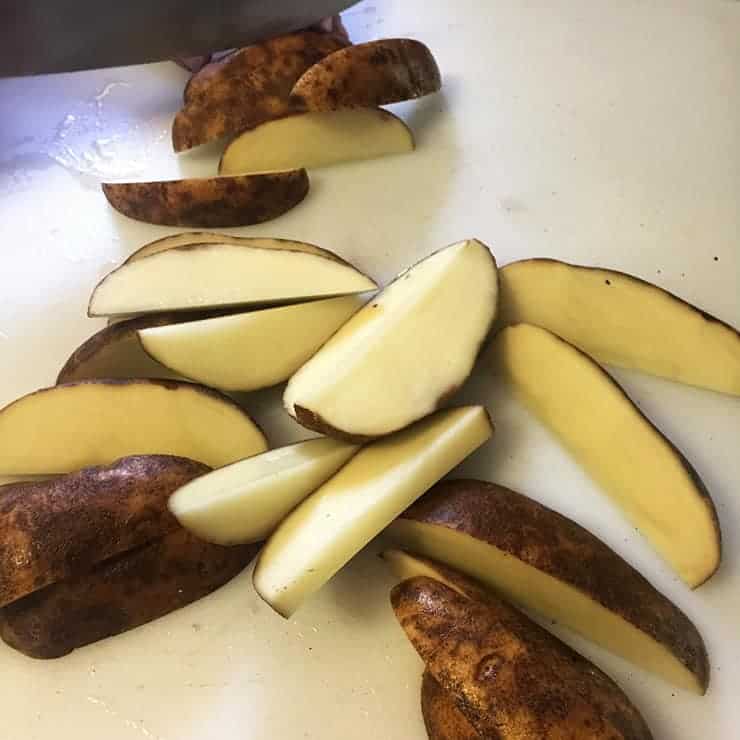 potatoes cut into wedges before they are boiled or grilled. Just to show the approximate size of these bad boys.