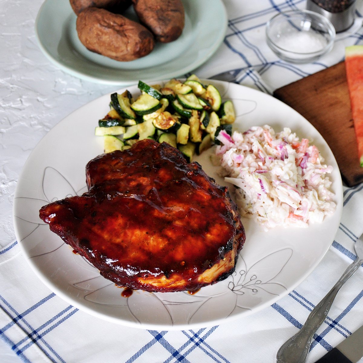 How to grill pork chops finished plate. A thick pork chop with coleslaw and zuchinni.