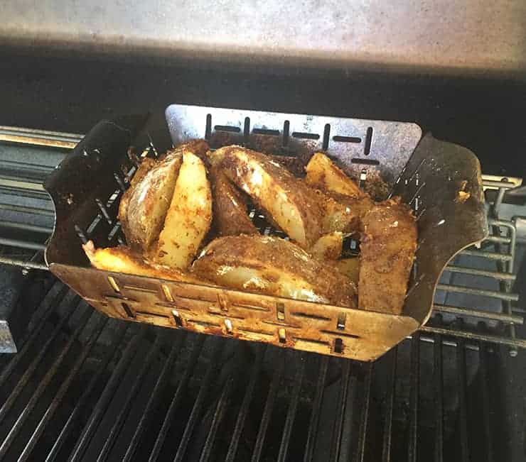 Grilling the potato wedges in my Weber vegetable tray