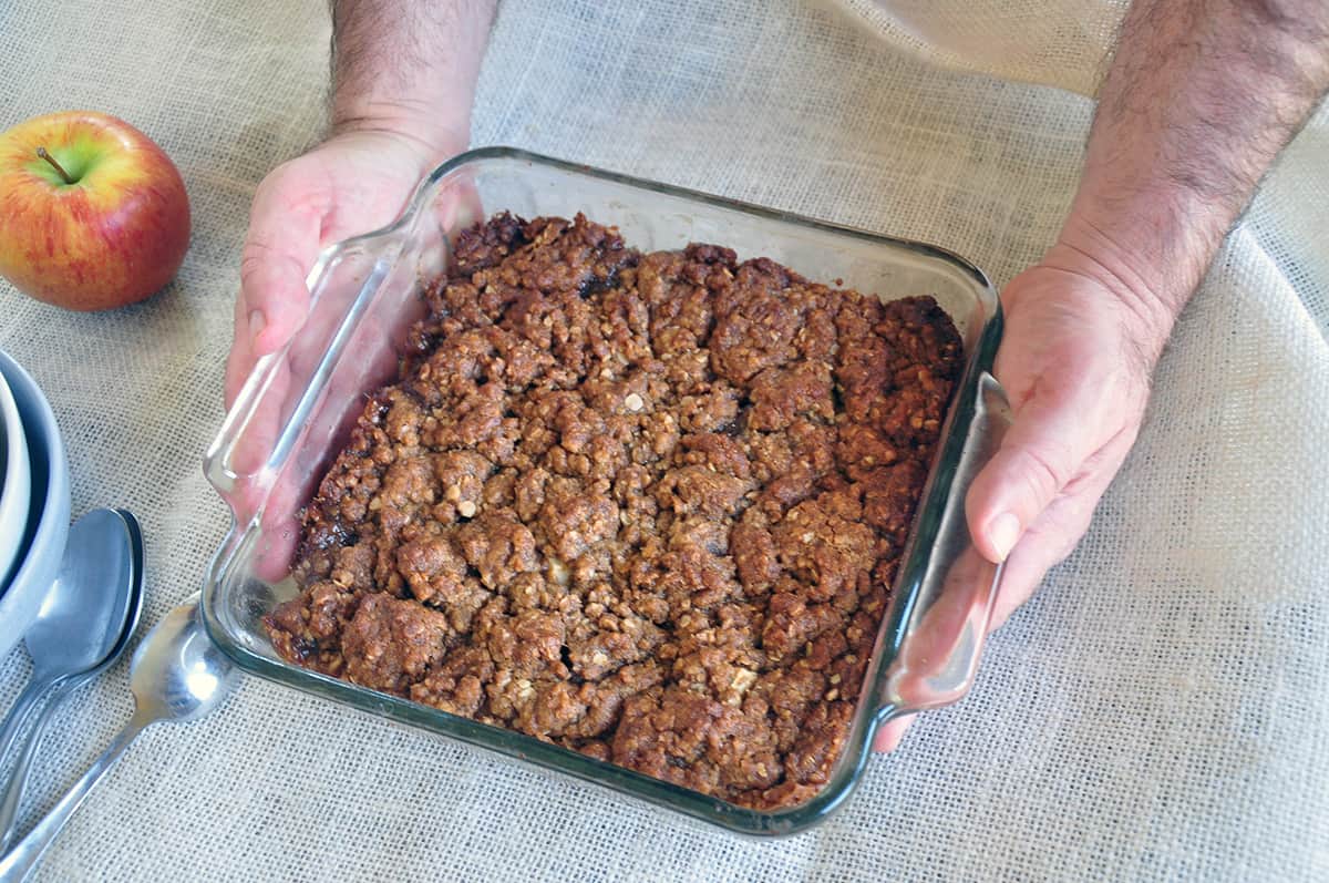 Hand holding Apple Crisp pan.