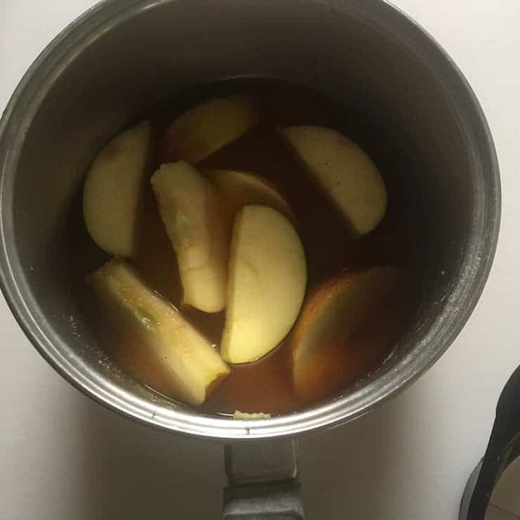 Simmering Apple Brandy liquid in saucepan