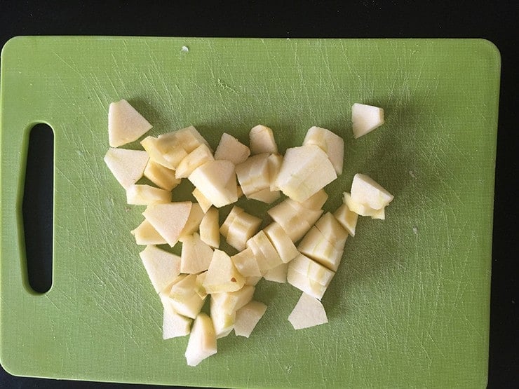 Chopped apple on cutting board.