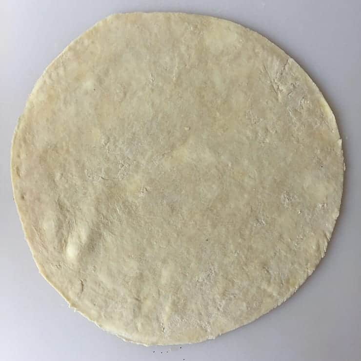 Cut Pie Crust Pie Crust circle with spots of Butter.