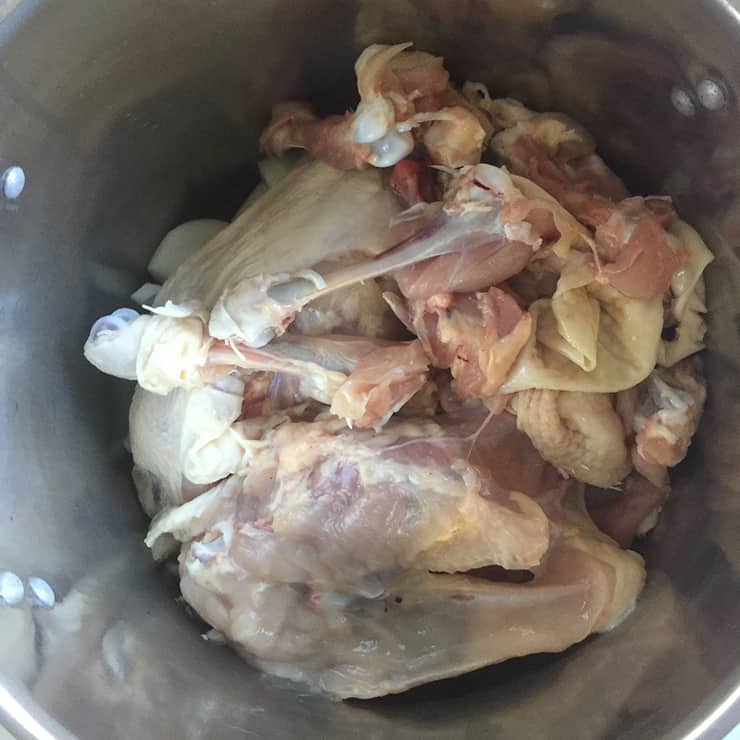 raw chicken in stock pot