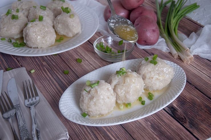 Pouring melted butter onto a klubb dumpling