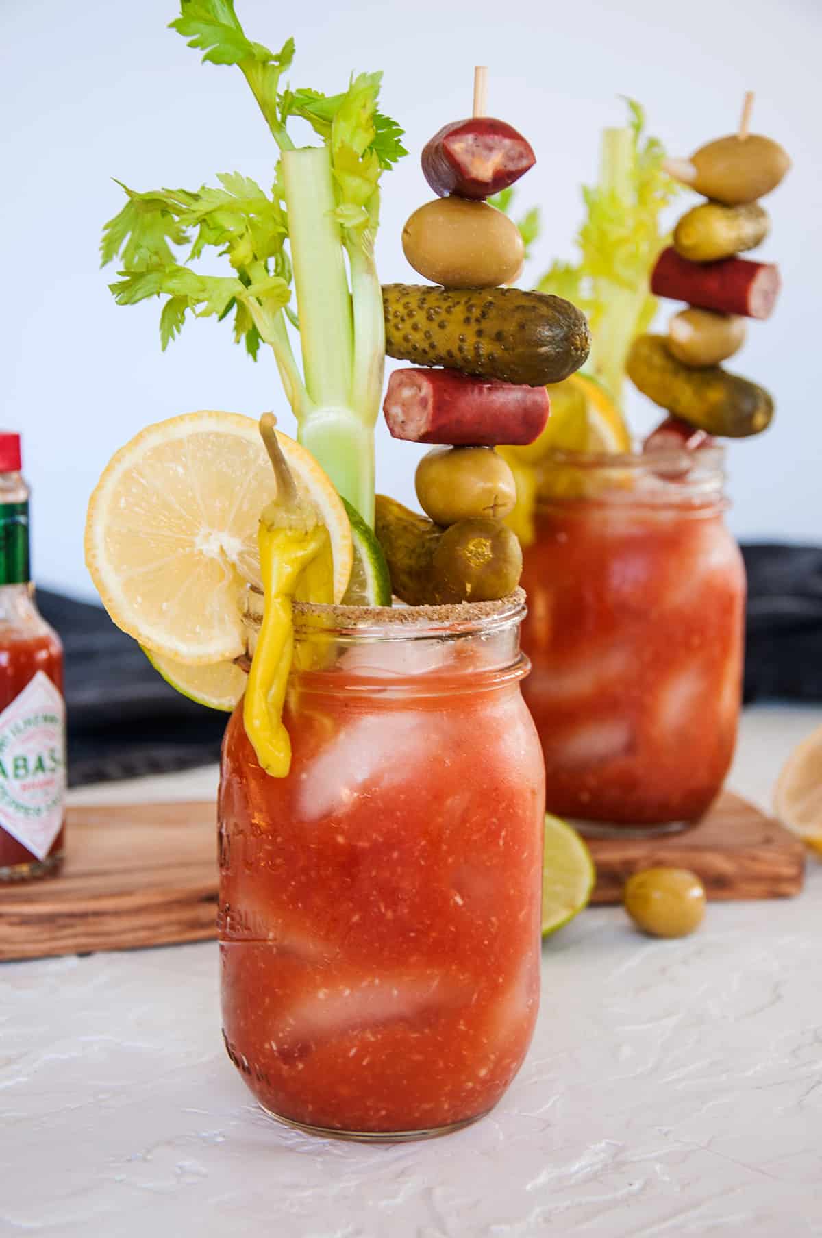 A good look at two stacked bloody mary drinks.