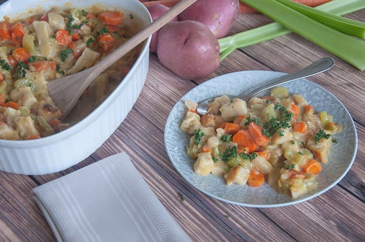 Casserole dish with one plate and a serving on it