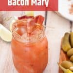 Bacon Bloody Mary on a White Table with a text overlay "Bloody Mary with a Twist - Bacon Mary"