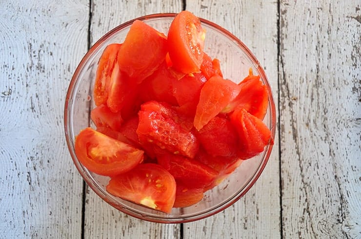 Sectioned tomatoes in a bowl.