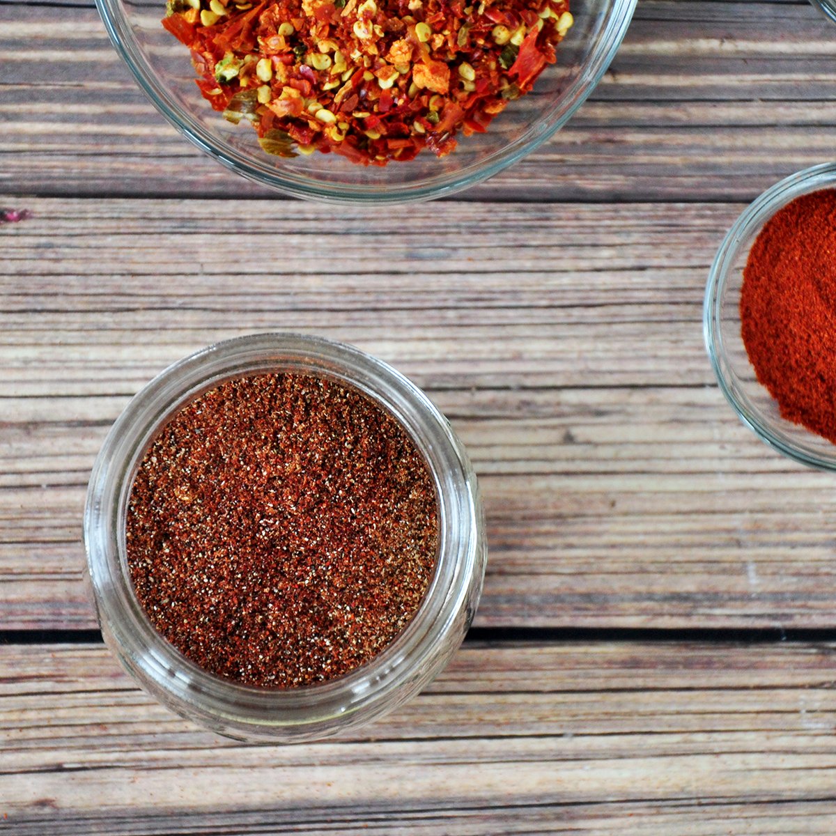 Overhead picture of homemade taco seasonings with paprika and red pepper on the side.