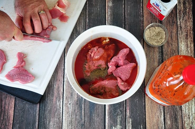 Adding eye of round roast to beef jerky marinate.