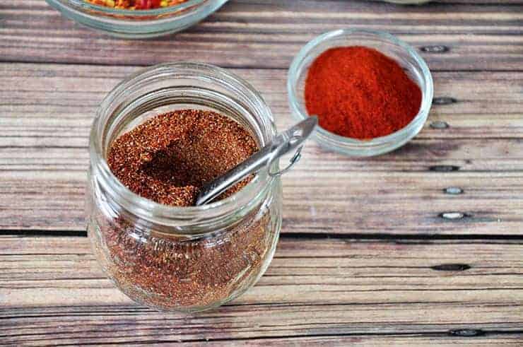 Bowl of taco seasoning with a scoop in it.