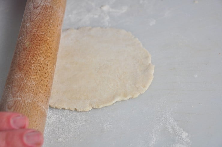 A flat and rolled out tortilla on a cutting board