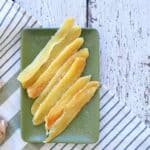 Dried Candied Ginger on a green plate and on a white table