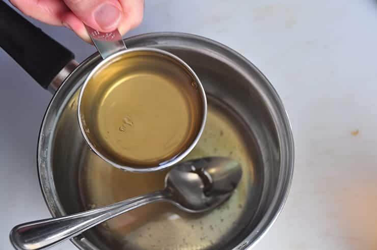 Pouring Honey into Ginger water to make Ginger Syrup.