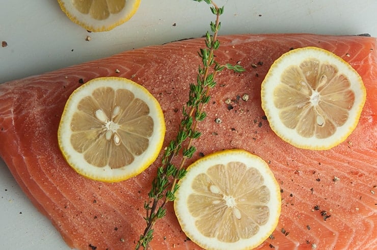 Lemon and thyme on salmon fillet.