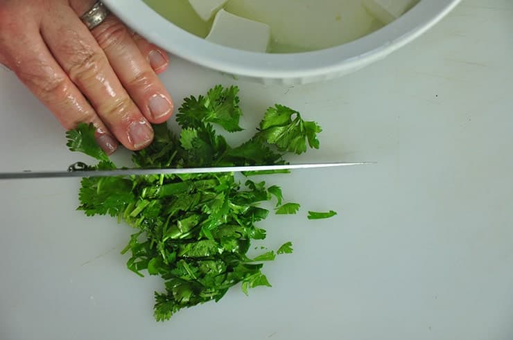 Cutting Cilantro on a cutting board