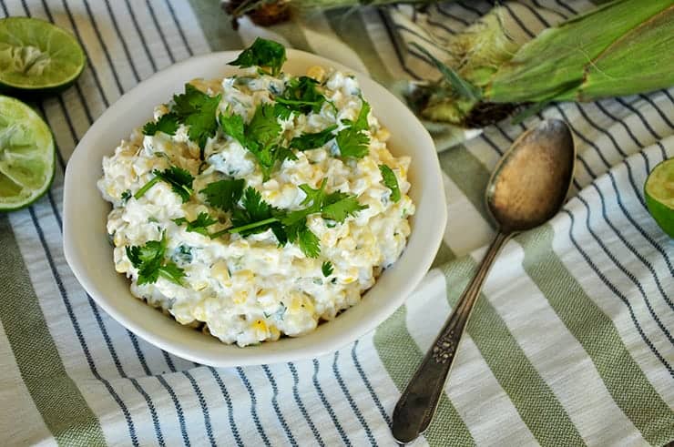 Grilled Mexican corn recipe on a green napkin.