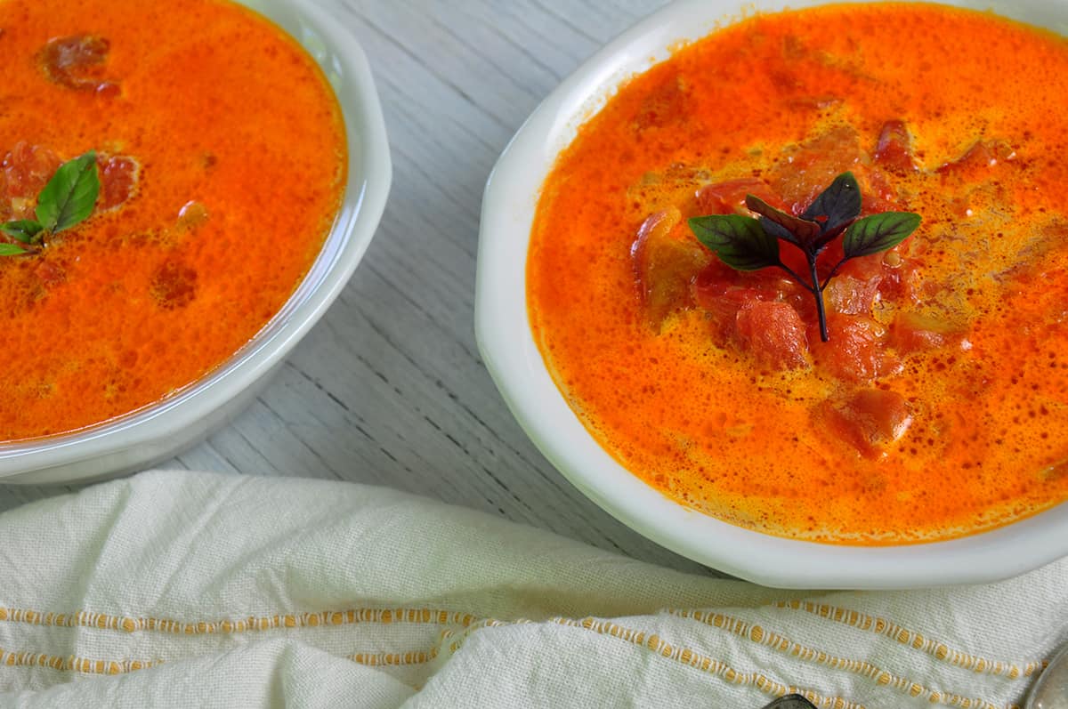 Two bowls of Rustic Tomato Soup on a white table