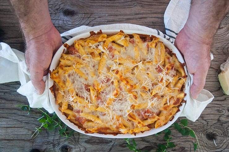 Holding finished Pasta Al Forno dish in casserole pan.