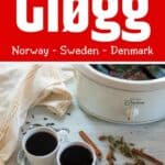 Traditional Drink - Glogg - with two coffee mugs filled with the drink and a glimpse of the crock pot.