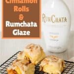 This Homemade Pumpkin Cinnamon Roll Recipe on a rack with rumchata in the background.