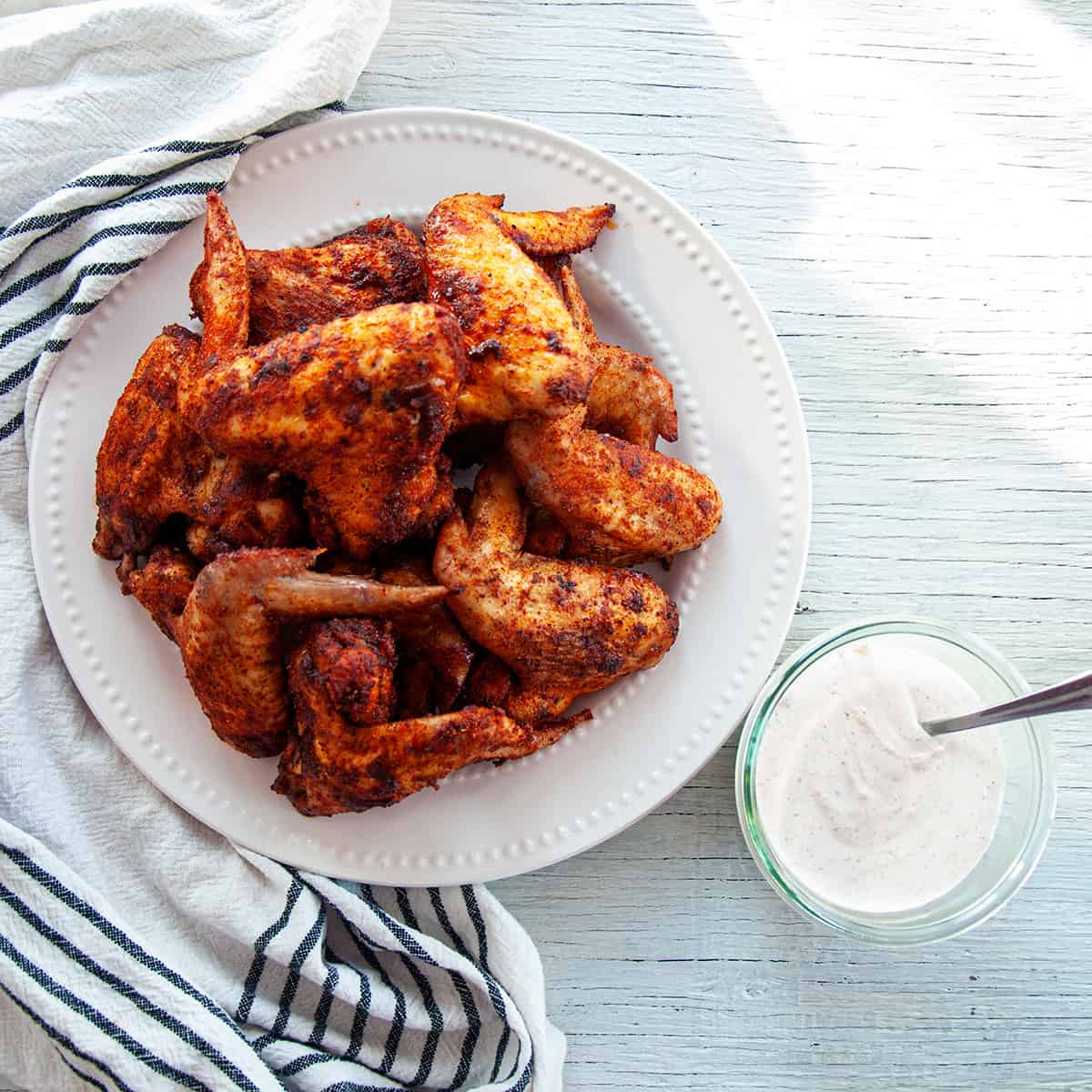 Plate of 10 Chicken Wings on a plate with a bowl of the chili lime dipping sauce.