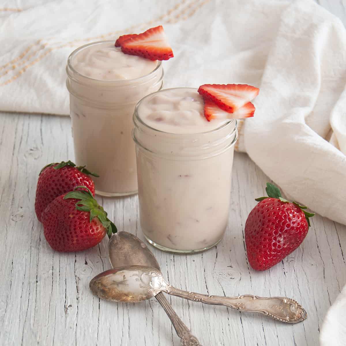 Overhead picture of two mason jars filled with strawberry pudding.