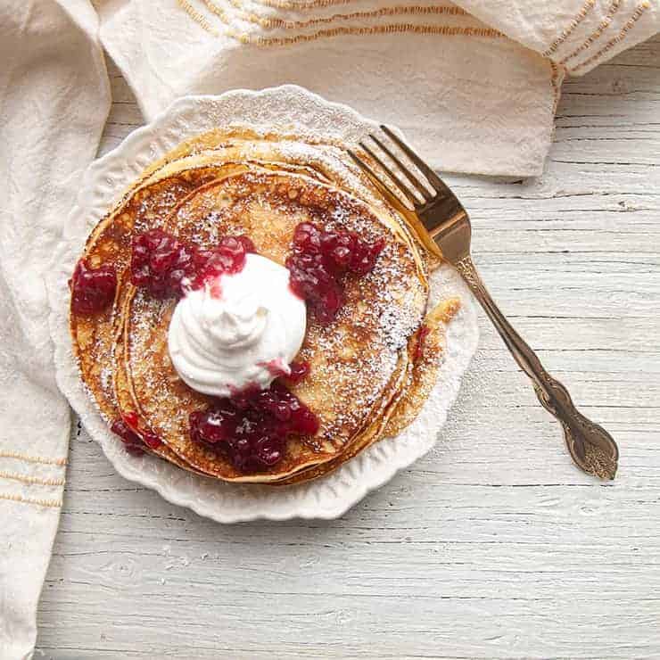 Top view of Swedish Pancakes with Lingonberry jam and Whipped cream.