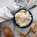 Make Ahead Sous Vide Mashed Potato in a blue bowl and mushroom gravy.