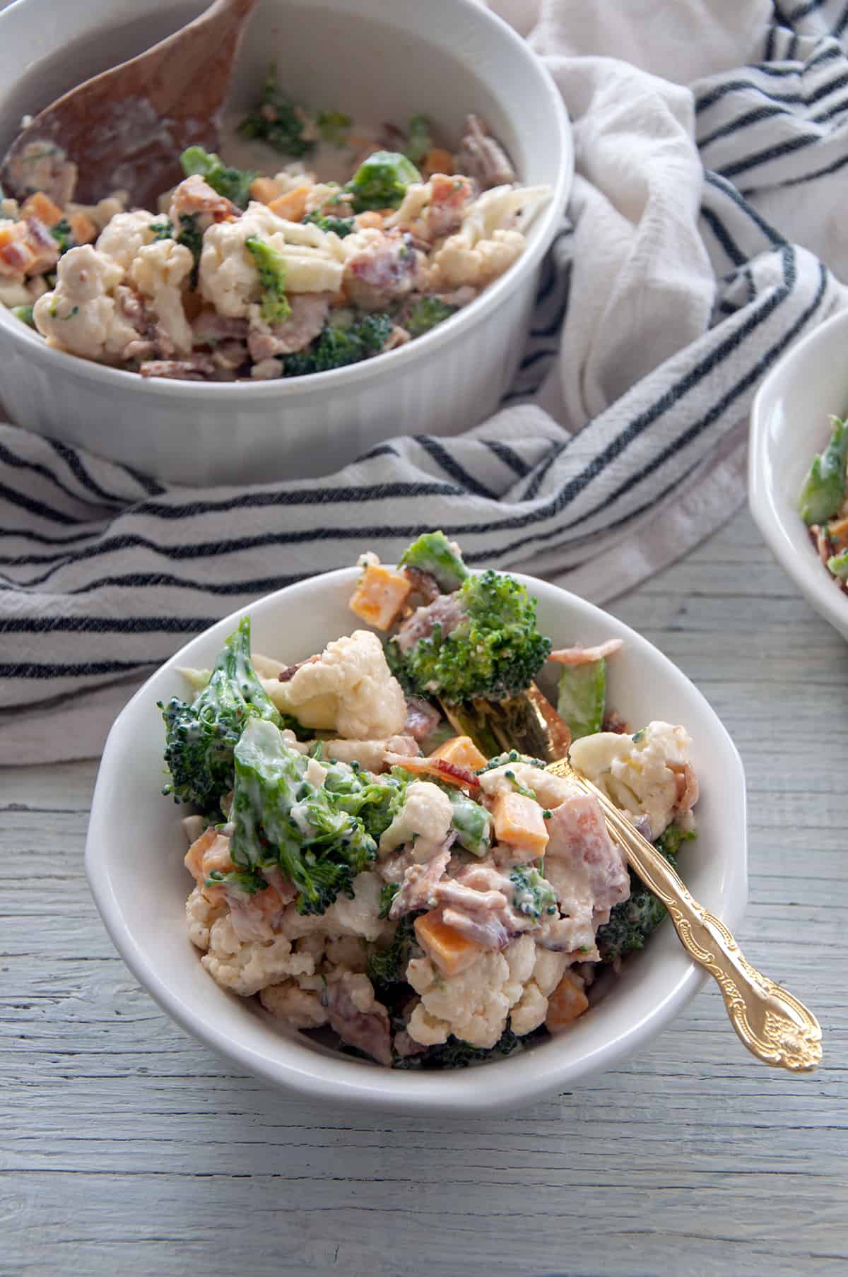 Bowl of Amish Broccoli Salad in a white bowl.