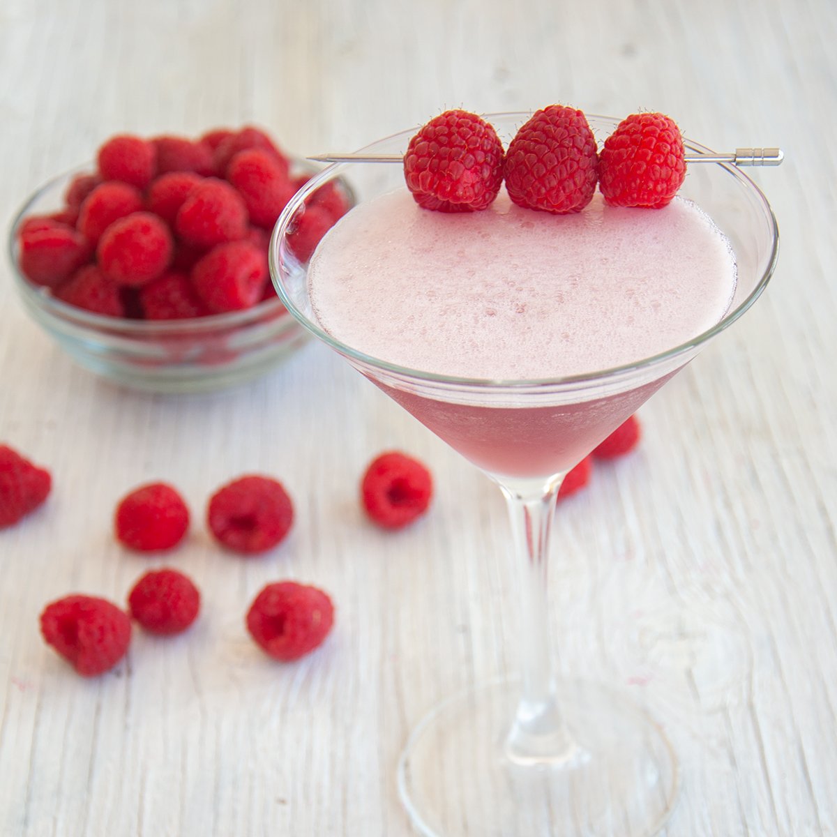 French Martini cocktail garnished with raspberries.