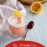 Gin Strawberry Jelly Cocktail with a spoon of jelly and spent lemon to the side.