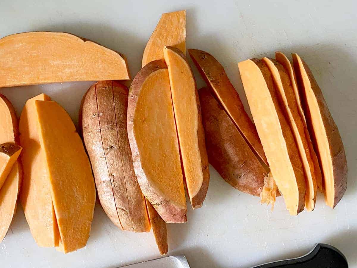 Process Picture depicting the cut sweet potato fries and demonstrating the width to cut to, about 1/2 inch.