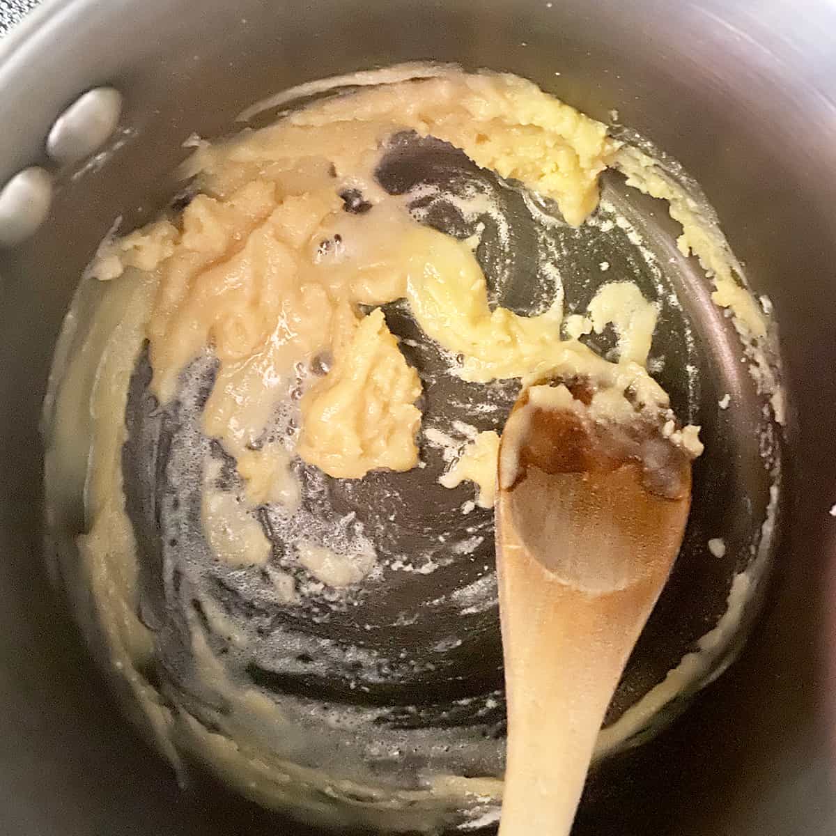 Pan with butter and flour in it being made into a roux before adding milk to thicken.