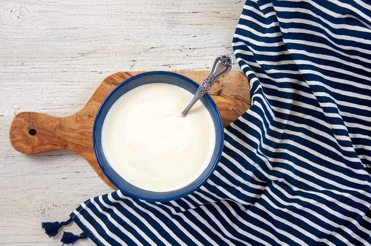 Overhead view of a bowl of homemade sour cream.