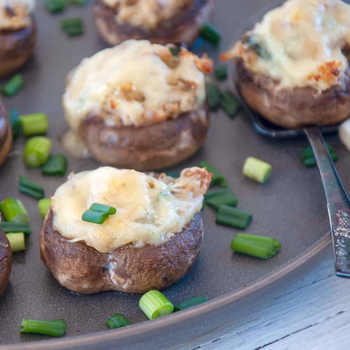 Crab Stuffed Mushrooms on a grey plate.