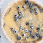 Blueberry tart on a white platter.